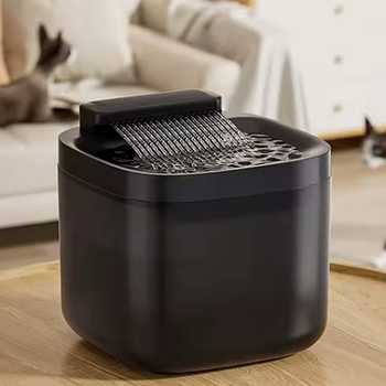 Black cat water fountain on a wooden table with two cats relaxing in the background